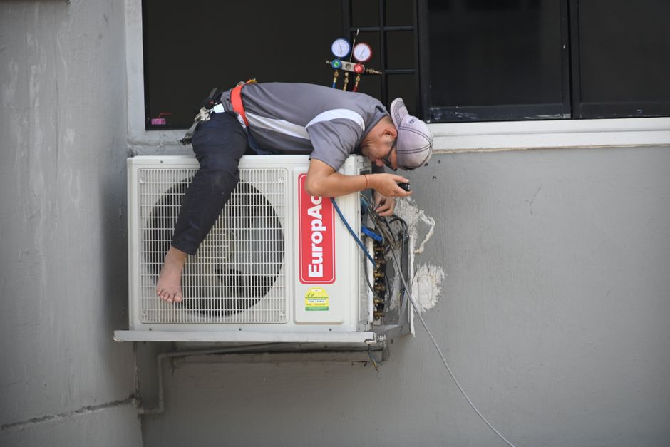 Friendly HVAC technician consulting with homeowner
